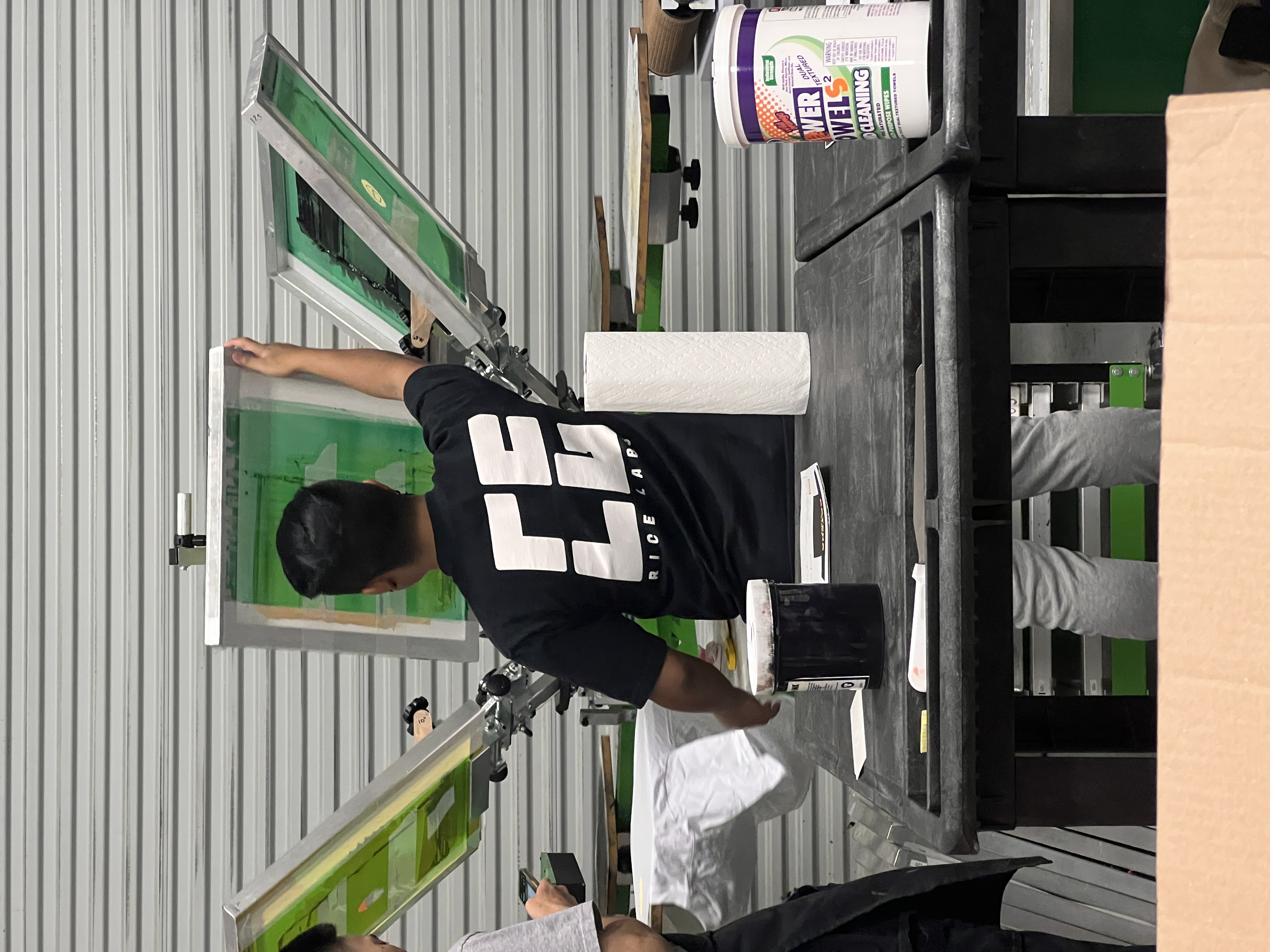 RICE LABS production operator working at a screen-printing press.